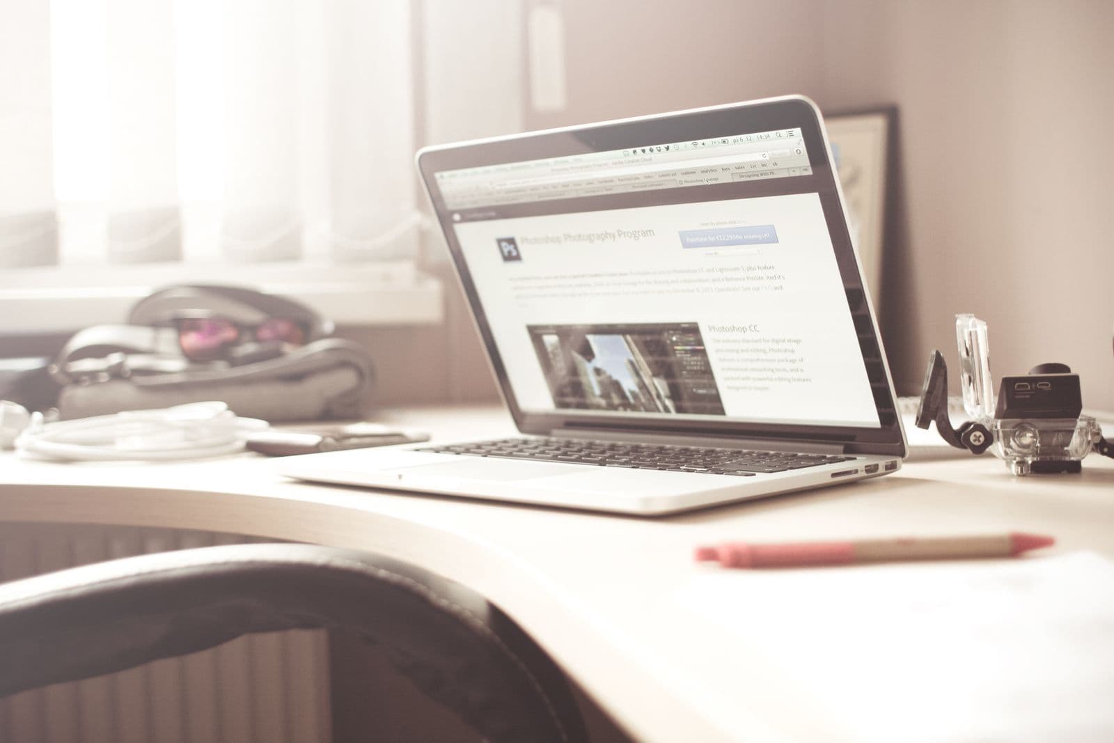 A laptop on a desk by a window displaying a website, representing a professionally built business site